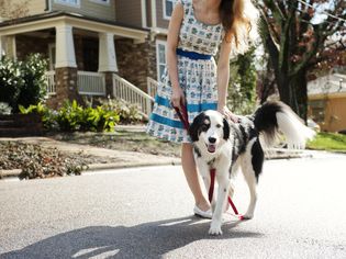 Young woman with dog in street