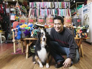 Dog and man in colorful pet store.