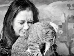 Photo of a sad woman holding a cat